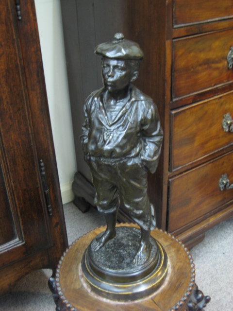 A Polish Bronze Figure Of A Boy